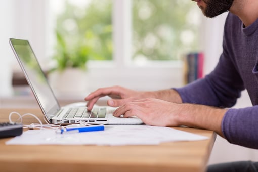 person typing on laptop